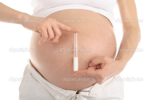 pregnant woman holding a test tube with sperm isolated on white