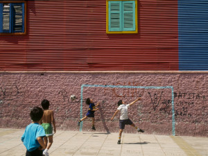 October 1995, Buenos Aires, Argentina --- Children playing soccer in the street in the Boca district of Buenos Aires. --- Image by © Jean-Yves Ruszniewski/TempSport/Corbis